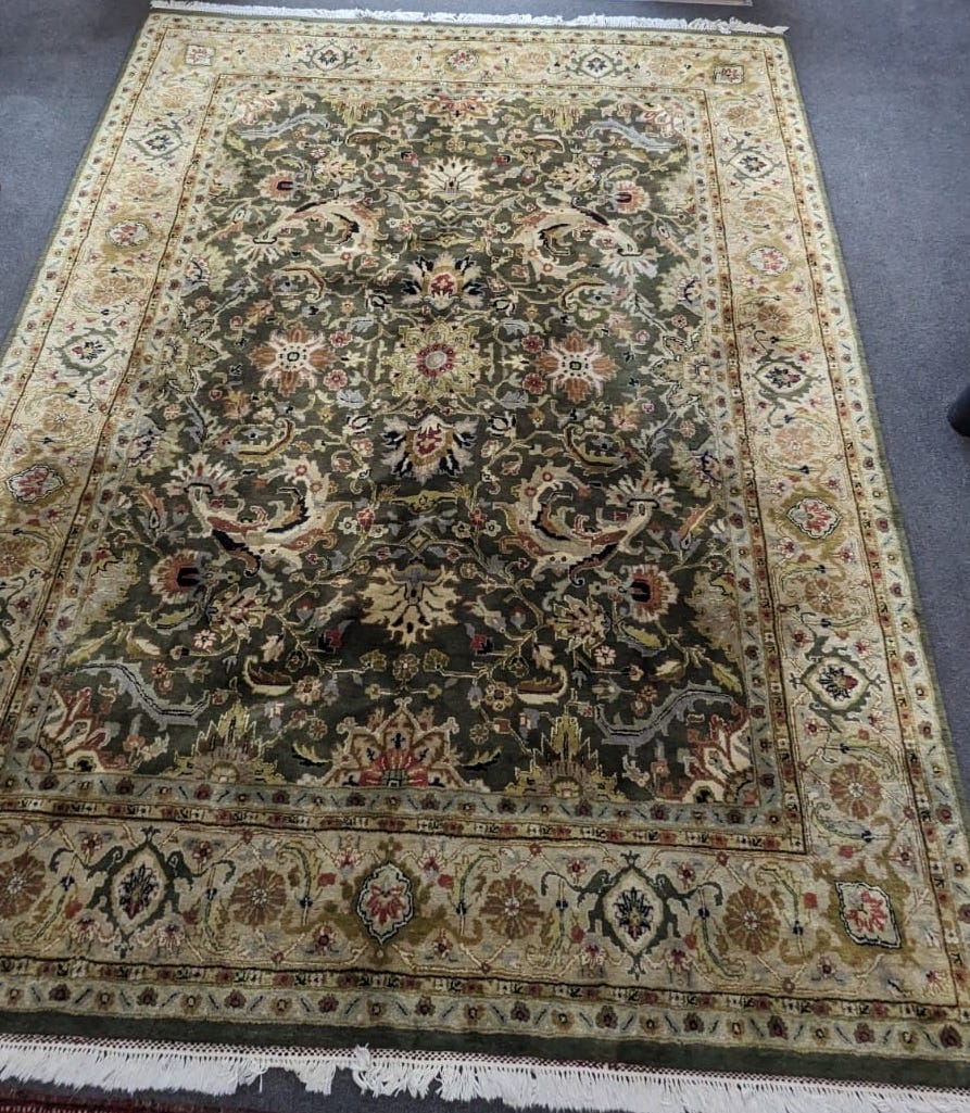 An Indian green ground floral carpet 300cm x 230cm